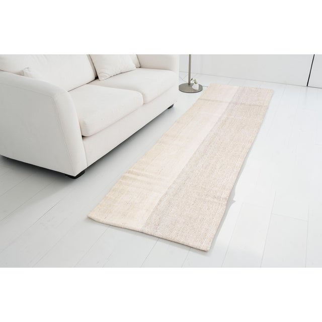 This is a vintage Turkish Oushak rug from the Mid 20th Century. The piece was hand-knotted.