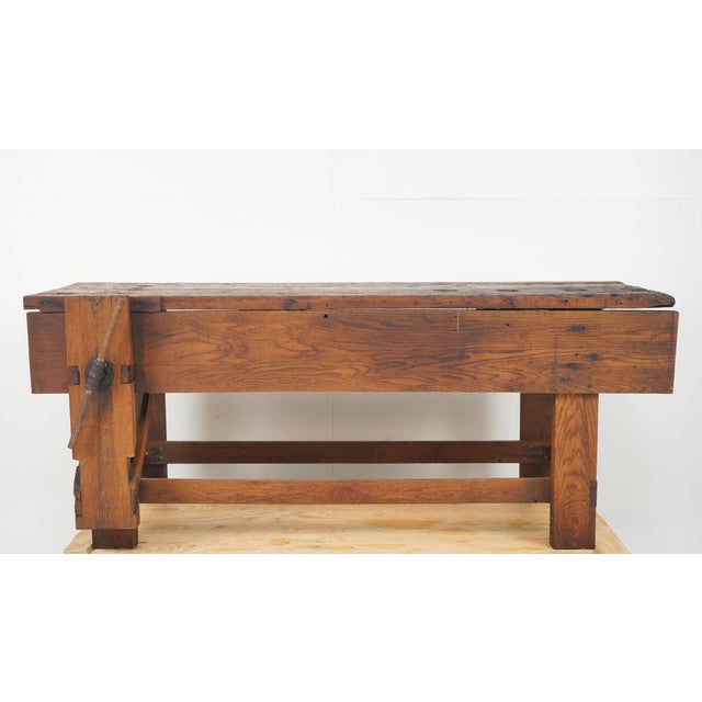 Vintage Industrial style carpenter's workbench with a simple design made of a mix of woods. The base is made of oak, and...
