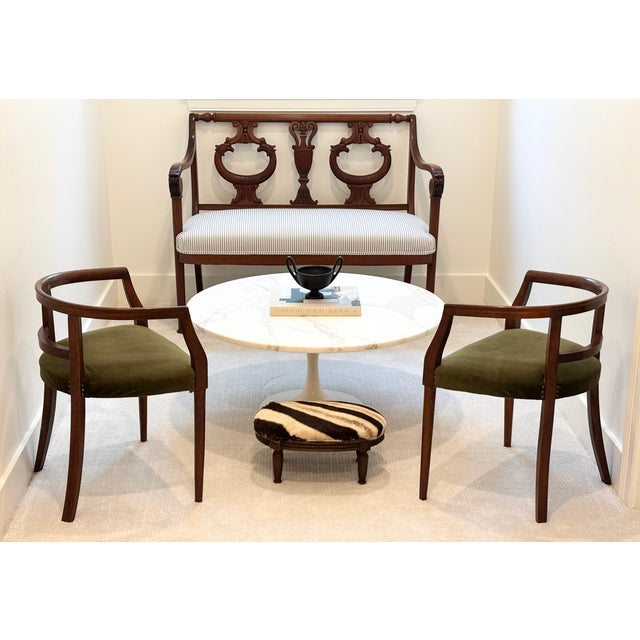 An elegant pair of Italian Mid-Century walnut horseshoe rail back armchairs. The low profile and petite scale make them...