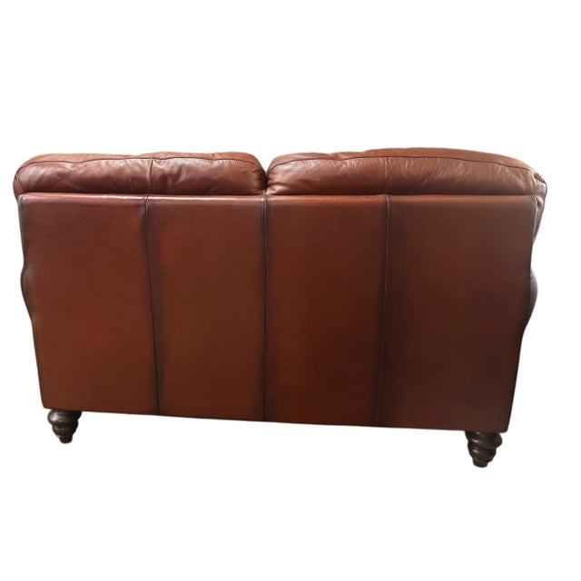 Italian-made Natuzzi Maturità loveseat upholstered in rich cognac protected top grain leather. Crafted June 2004 and...