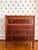 With the lighter color of its cherry case contrasting with the darker, beautifully figured mahogany of its drawer faces,...
