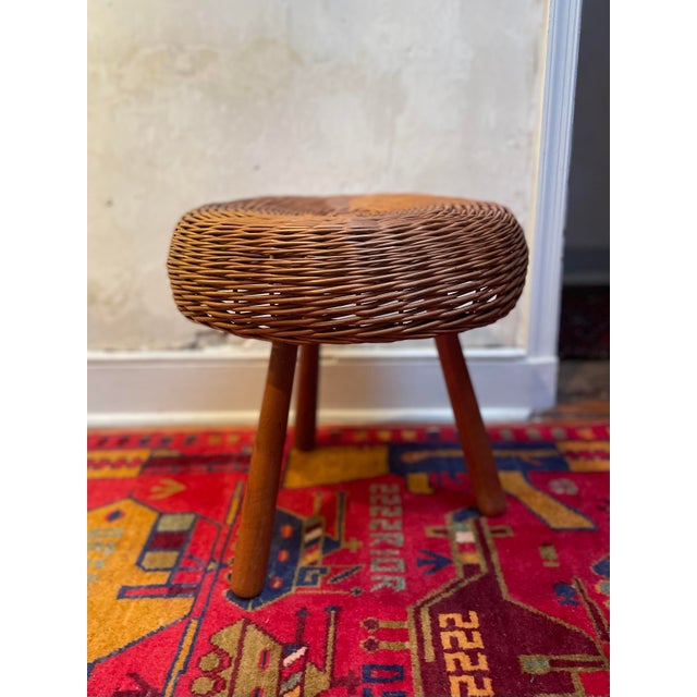 A 3 legged woven wicker and beech stool attributed to Tony Paul circa 1960s. 17.5" diameter x 17" height.