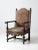 This is an antique Louis XIII style arm chair from the 19th century. Decoratively carved, the wooden arm chair features a...