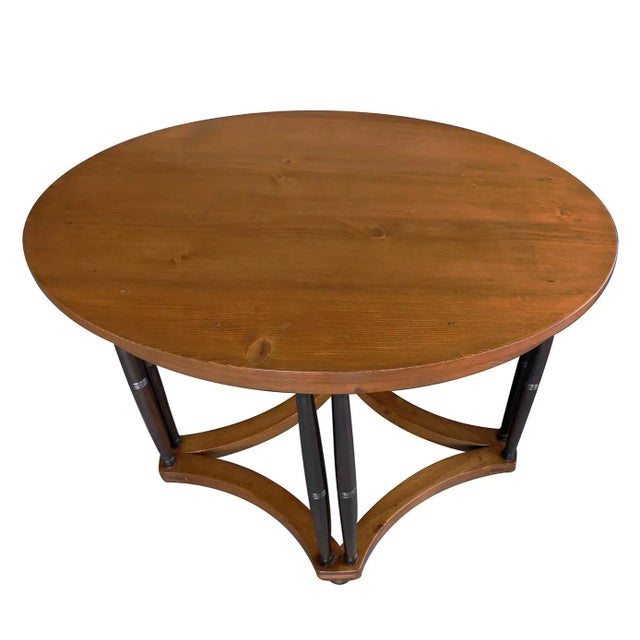 The oval top above a plain frieze apron all raised on deep-brown stained cluster column supports ending in bun feet; all...