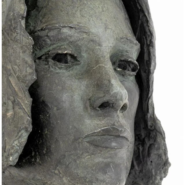 Lily Landis (American, b. 1918) Bronzed Spelter Female Portrait Bust, signed to the verso, mounted on ebonized cube base....