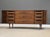 A mid century modern walnut eleven drawer dresser with rosewood and brass drawer pulls made by Kroehler Furniture....
