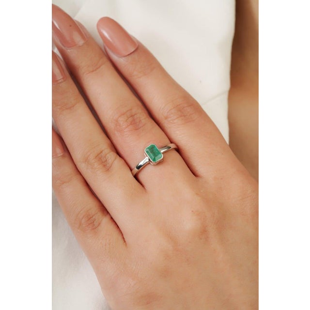 Featuring a 4×6 mm octagon-cut emerald gemstone weighing 0.57 carat, this 925 Sterling Silver Emerald Ring is a sleek and...