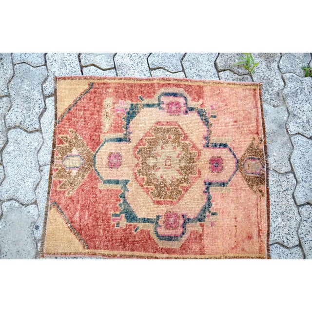 This is a vintage Turkish Oushak rug from the 1960s. The piece was hand-knotted.