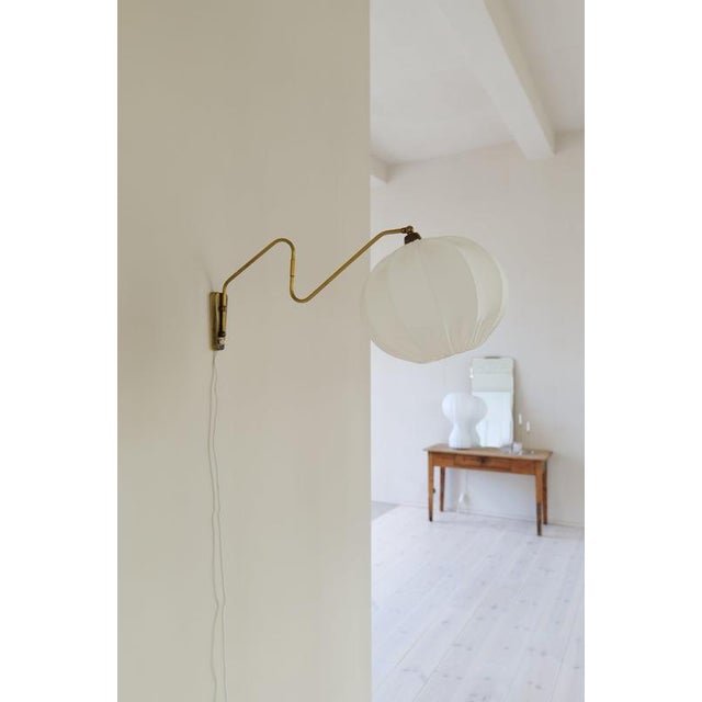 A typical Scandinavian wall light in brass made during the 1960s. This one with gifted with the possibility to turn the...