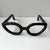 Contemporary black metal art sculpture of a pair of oversized cat-eye eyeglasses. Unsigned. Exact age is unknown. In the...