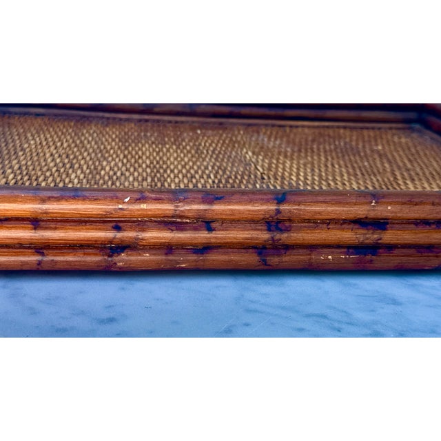 Vintage 1970s Bamboo and Rattan Tray with handles. The tray has a beautiful rattan and cane top, and the piece is in...