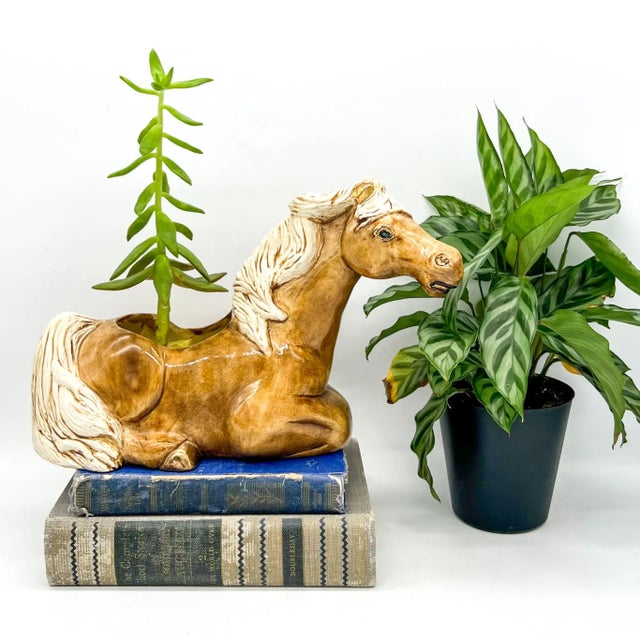 Charming vintage ceramic horse planter featuring a soft caramel brown glaze, creamy white mane and tail, and hand-applied...