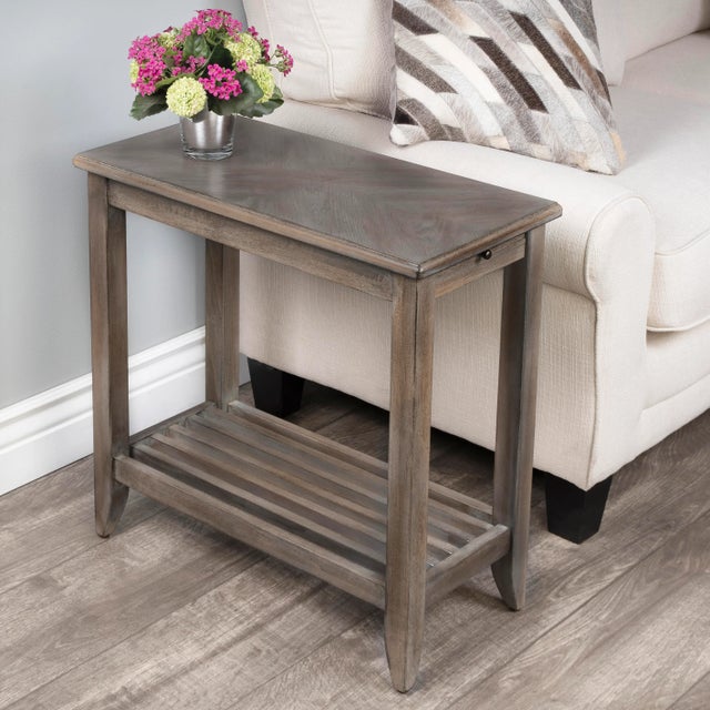 This chairside table is the ideal blend of function and design, complete with a pull-out shelf for a beverage and a comely...