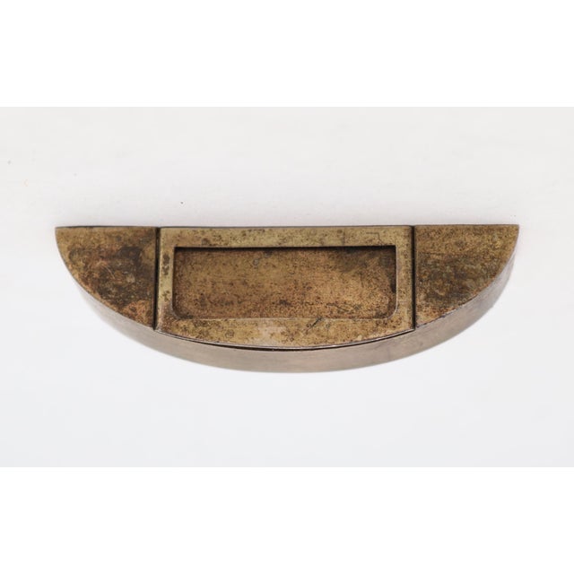 Reclaimed semi circle shaped brass drawer pull with a label slot. Inscribed No 328, D.C. Capt. HDWE., Chicago, ILL. The...