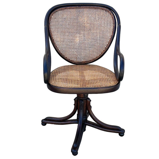 Victorian bent oak & cane number 11 oak swivel desk chair by Thonet features an elegant, sculptural frame crafted from...