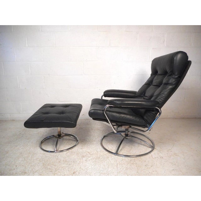 Stylish contemporary modern reclining lounge chair with matching ottoman. Comfortable padded seating with tufted faux-...