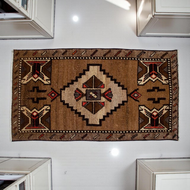 Welcome to our curated collection of authentic Anatolian textiles. This exquisite vintage small rug is a beautiful...