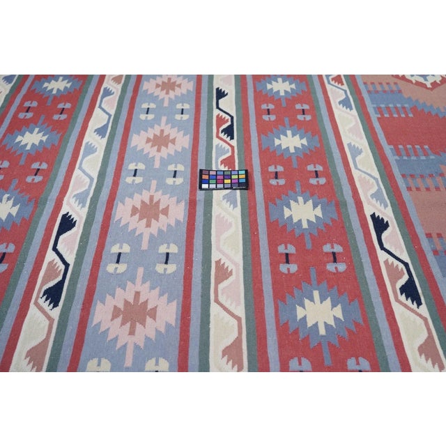 This banded Shirvan-style pileless flatweave is executed in the warp-shared technique in which color transitions meet at a...