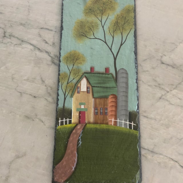 One-of-a-kind hand painted slate wall tile featuring a rustic green barn in a meadow by a silo. Great as a decorative...