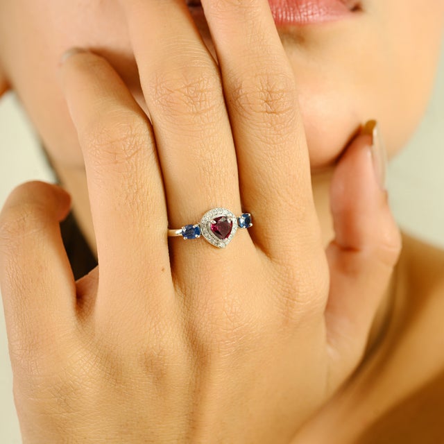 A captivating blend of color and brilliance, this exquisite ring is crafted in 14k white gold and features a 0.97 carat...