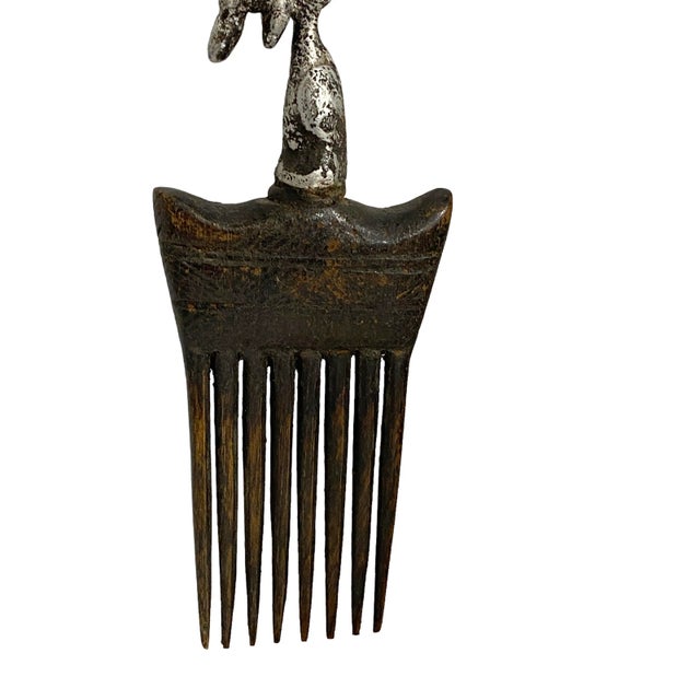 An amazing vintage wood comb with a Aluminum Bird Head figure on the top decorated with geometric carvings,The Akan...