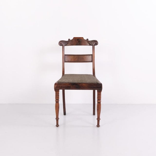 Pair of antique late empire salon chairs from the 1840s, made of mahogany. The chairs feature classically shaped backs and...