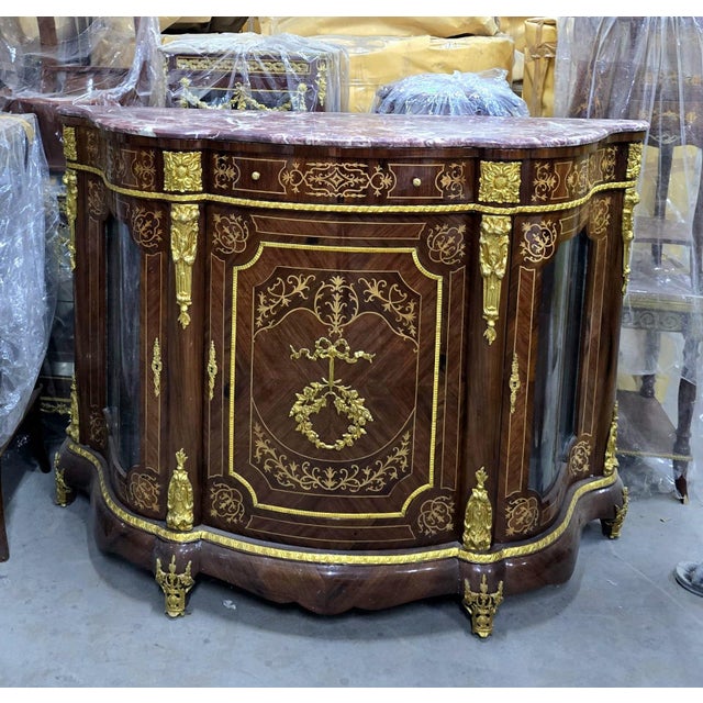 Introduce timeless grandeur into your home with this magnificent French Louis XVI display commode cabinet, masterfully...