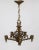 A brass chandelier with 5 arms of radial, webbed, arrows arcing to the center stem. Made by Lightolier in the early 20th...