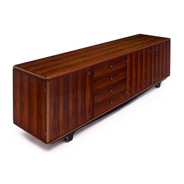 Credenza from the period mid-century modern era in France. This piece is made of solid wood construction with a beautiful...