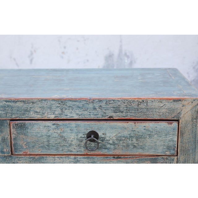 A distinctive vintage Chinese cabinet crafted from solid pine, dating to the first half of the 20th century. The long...