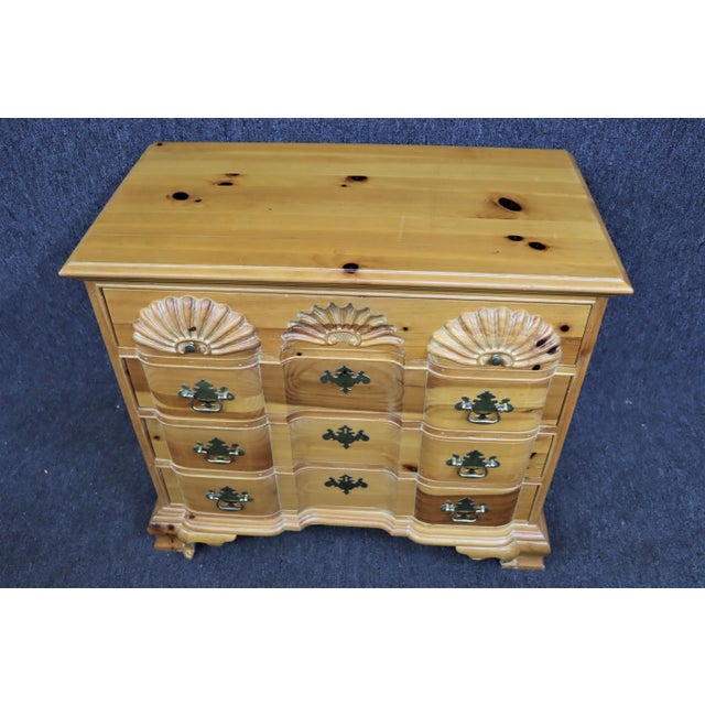 Chippendale style block front chest , made of knotty pine , 4 drawers , carved shell design on top drawer , ogee bracket feet