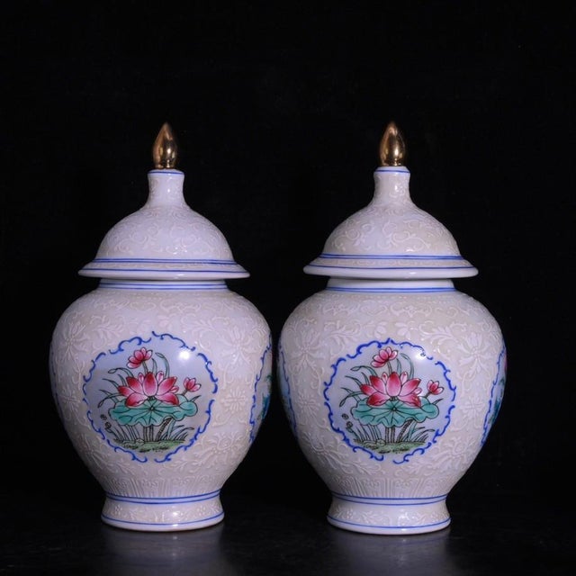 A beautiful pair of Chinese white glazed porcelain covered jars. The body features a subtle, intricately incised (anhua)...