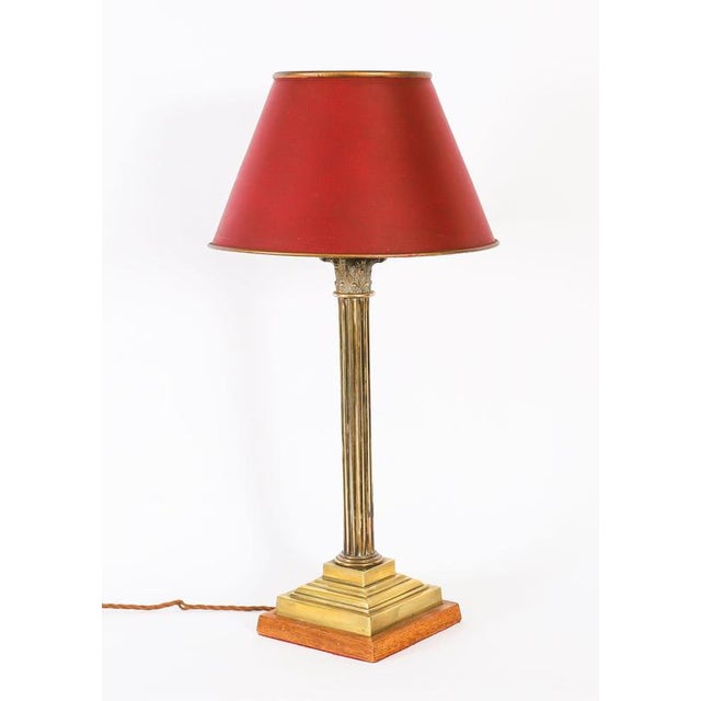 This is a stunning antique pair of Regency Revival brass Corinthian column table lamps with brass shades, circa 1890 in...