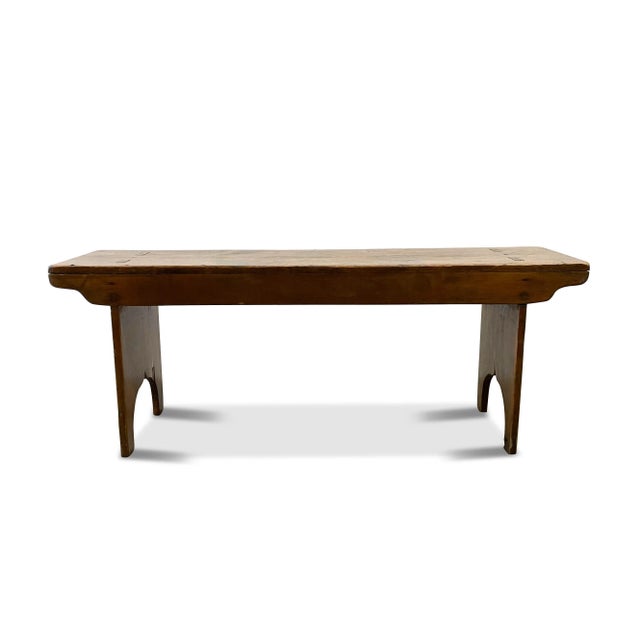 A handmade antique farmhouse bench from the mid 19th century. This rustic wood bench has square nails to secure the side...