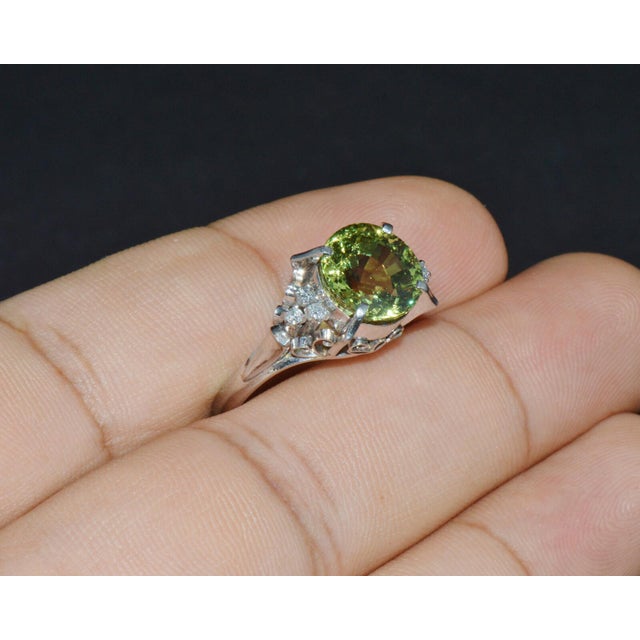 Gorgeous estate solid 900 platinum 3.74CTS diamond and peridot ring. This ring features a magnificent round brilliant-cut...