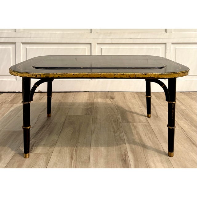 Here is a handcrafted faux bamboo coffee table by Jan T. Zoltowski, featuring a black lacquer and gilt frame surrounding a...