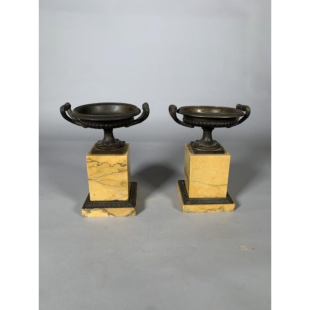 Important mantelpiece set, clock with horse motif and pair of cassolettes in the Charles X Restoration style. Siena yellow...