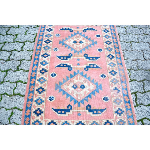 This is a vintage Turkish Oushak rug from the 1960s. The piece was hand-knotted.