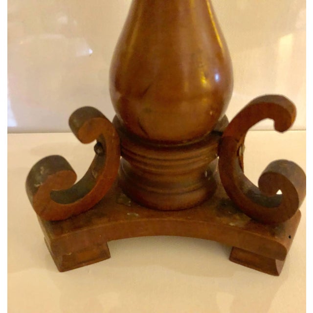 The turned baluster shaped candlesticks with C-scrolls applied to tripartite base.