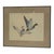 Framed wildlife print depicting two ducks in flight, rendered in a detailed natural style. The composition features two...