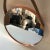 Round Copper mirror with an attached leather strap. Adds a nice, clean minimalistic, or industrial style to any room decor...