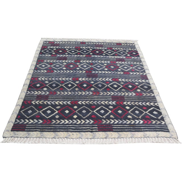 Hand-knotted with care using traditional rug-making techniques, this wool rug blends timeless craftsmanship with a modern...