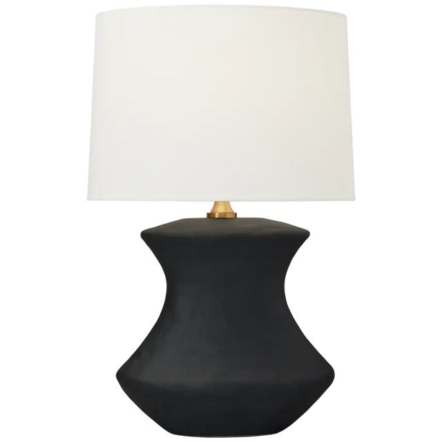 Hand crafted in ceramic the Bone one light table lamp by Hable has a unique shaped base and a black or white finish,...