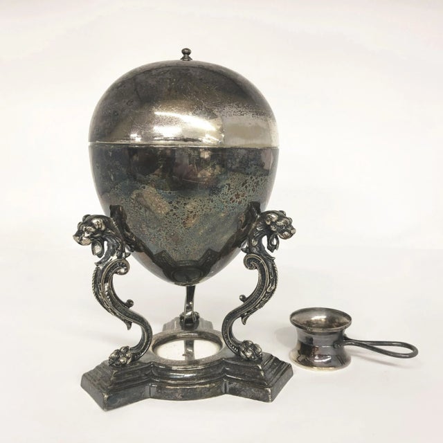 Vintage Egg Warmer, c. 1920, in silver plate, featuring three dragons on scrolled legs of the warmer base. Once a...