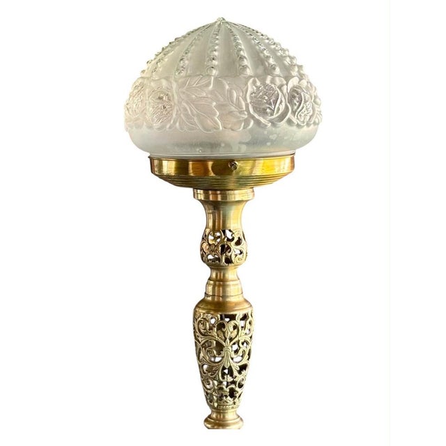 French Art Deco lamp, circa 1940, made of openwork gilt brass with floral motifs. The shade is made of molded glass with a...