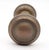 Vintage concentric passage door knobs made of brass with a muted patina finish. Priced as a pair of knobs with a spindle....