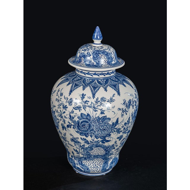 A classic interpretation of the timeless Blue Delft style, this lidded ceramic urn features intricate hand-painted...