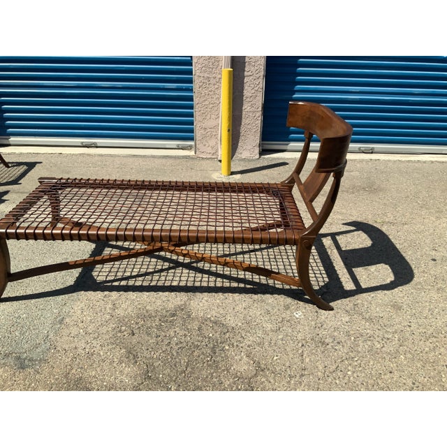 Sophisticated modern chaise lounge in the manner of Robsjohn Gibbings Klismos. The chaise has a dark walnut finish, with...