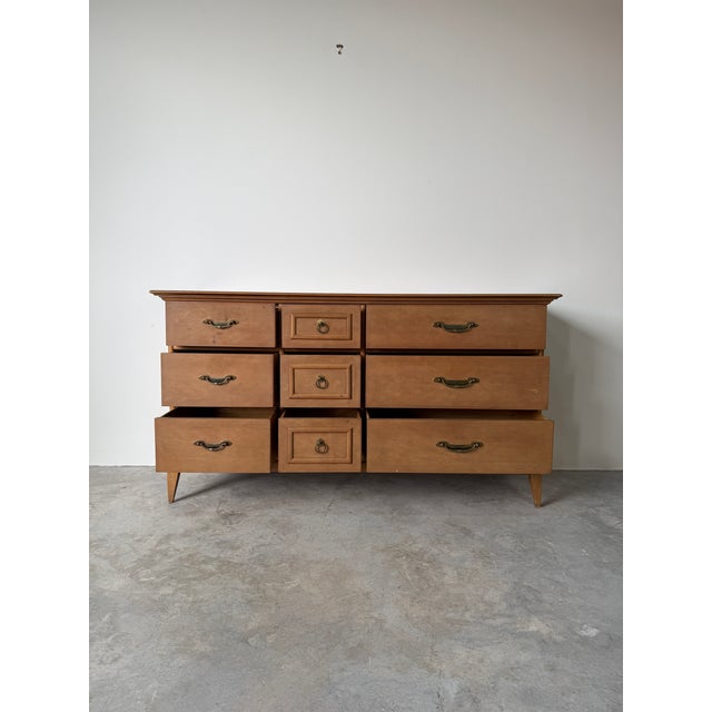 This vintage Broyhill Premier Division dresser showcases timeless American craftsmanship with a clean, mid-century...