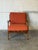 Featuring sculpted paddle armrests and a vertical spindle back frame, this lounge chair offers refined architectural...